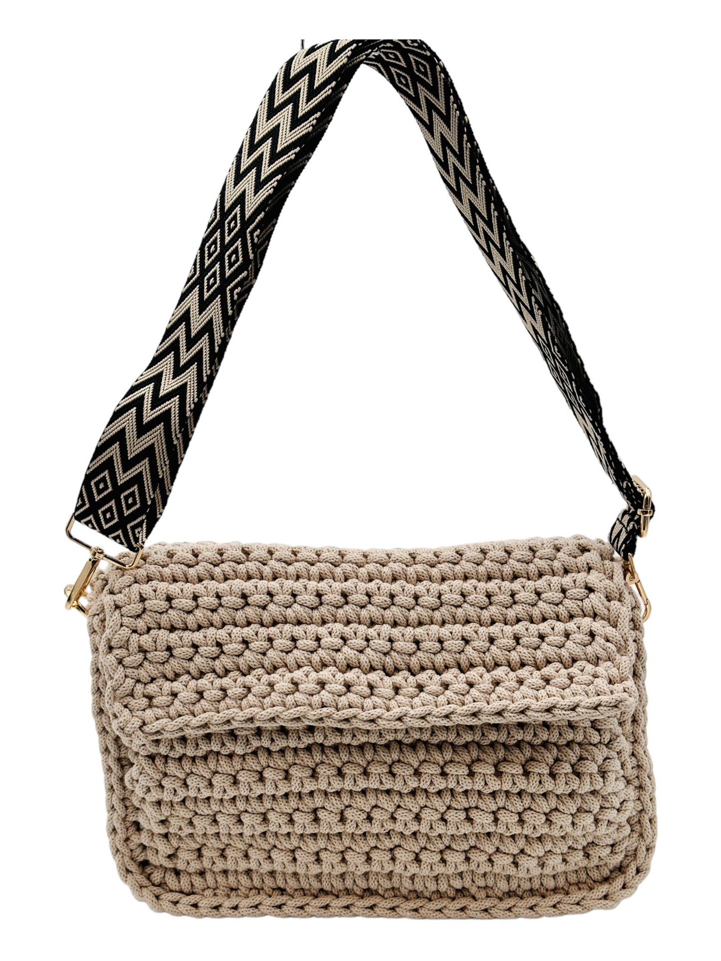 Ein Foto einer handgefertigten Crochet-Tasche in Beige vor einem weißen Hintergrund. Der Tragegurt ist schwarz und zeigt ein dezentes Beige-Muster.